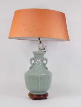 A Chinese celadon glazed table lamp, of baluster form, flanked by elephant mask ring handles, height