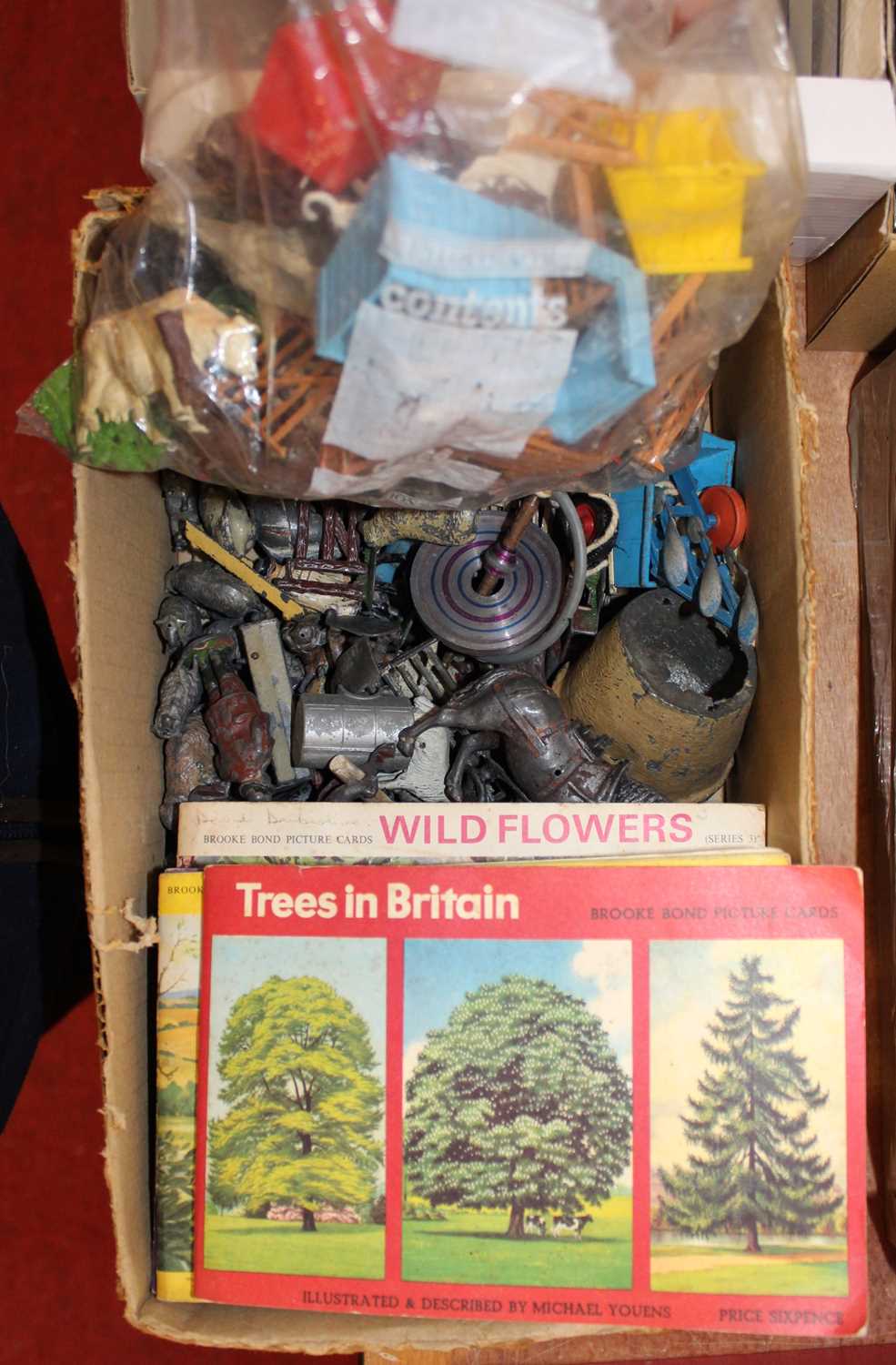 A small quantity of Britains farm lead and plastic figures, together with various booklets