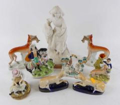 A collection of nine Victorian Staffordshire flat back figures, to include dogs, and a horseback