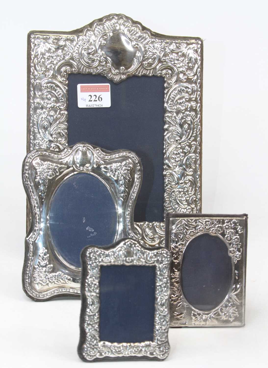 A modern repousse decorated silver easel photograph frame, in the Victorian taste, Sheffield, 14 x