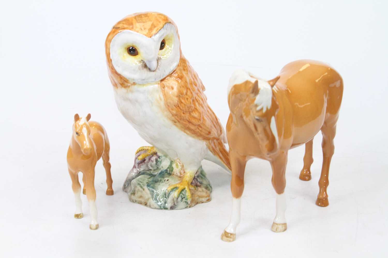 A Beswick model of an owl, No. 1046, h.19cm; together with a Beswick model of a horse and foal (3)