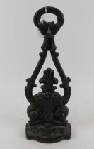 A black painted cast iron doorstop, in the form of a shell, height 41cm