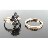 A modern 9ct gold and sapphire cluster ring, the shoulders each pavé set with three smaller white