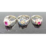 A 9ct gold, blue and white paste set cluster ring, size N; together with two 9ct gold ruby and white