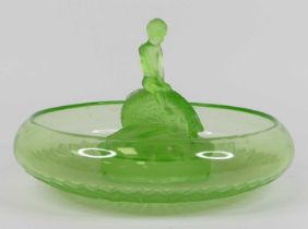 An Art Deco green glass centrepiece, in the form of a boy riding a fish, dia. 35cm Chips to the base