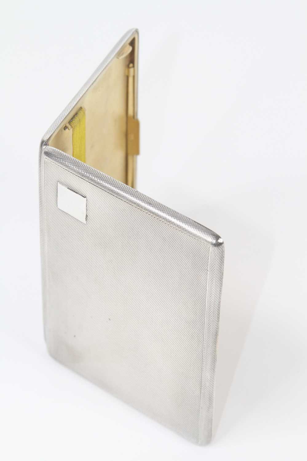 A George V silver cigarette case, of typical hinged rectangular form, having all-over engine