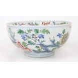 A Chinese porcelain bowl, enamel decorated with birds amongst flowers, dia.19cm Some fritting to the