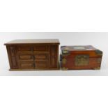 An oak table top jewellery box in the form of a continental chest, having three short drawers