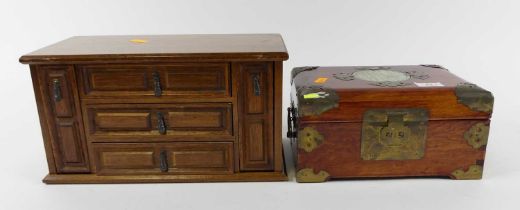 An oak table top jewellery box in the form of a continental chest, having three short drawers