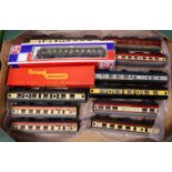 Three trays containing 00 gauge related trains and accessories to include a large quantity of