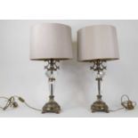 A pair of modern brass and cut glass table lamps, each having a beige shade, height including