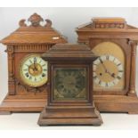 An early 20th century continental oak mantel clock, h.32cm; together with two other similar