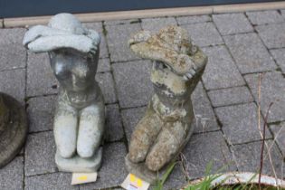 A pair of reconstituted stone garden figures of kneeling nude maidens, height 51cm