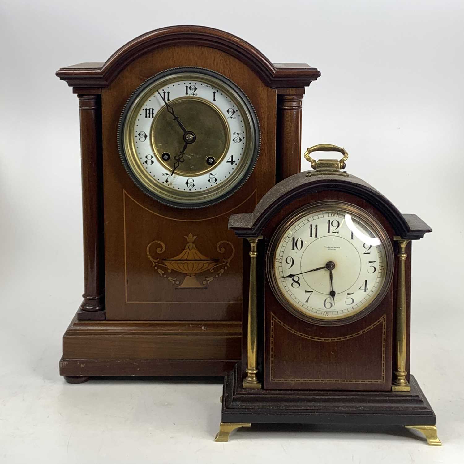 An Edwardian inlaid mahogany mantel clock having an Arabic chapter ring and eight-day brass cylinder