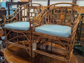 A pair of stained bamboo and wicker tub elbow chairs, in the Chinese taste, w.58cm