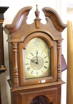 A reproduction faux walnut long case clock, having three train musical movement, height 185cm (