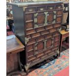 A Chinese elm and silvered metal mounted side cabinet, having four cupboard doors and four short