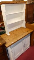 A modern pine and part white painted dresser, having two-tier open plate rack over base with twin
