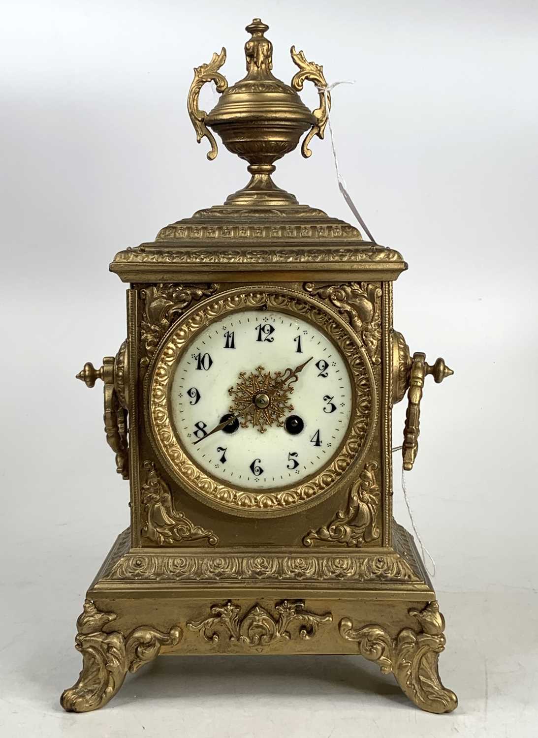A late 19th century gilt brass (re-gilded) mantel clock having an unsigned white enamel Arabic dial,