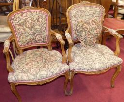 A pair of French provincial walnut framed and floral needlework upholstered fauteuil, w.59cm