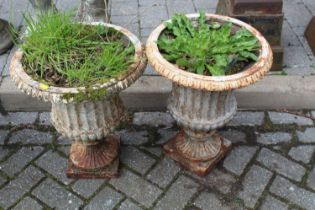 A pair of white painted cast iron pedestal garden urns, in the classical taste, height 50cm