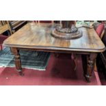 A mid-Victorian mahogany round cornered extending dining table, having wind-out action and two extra