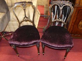 A set of four mid-Victorian ebonised and gilt decorated salon side chairs, having plush purple