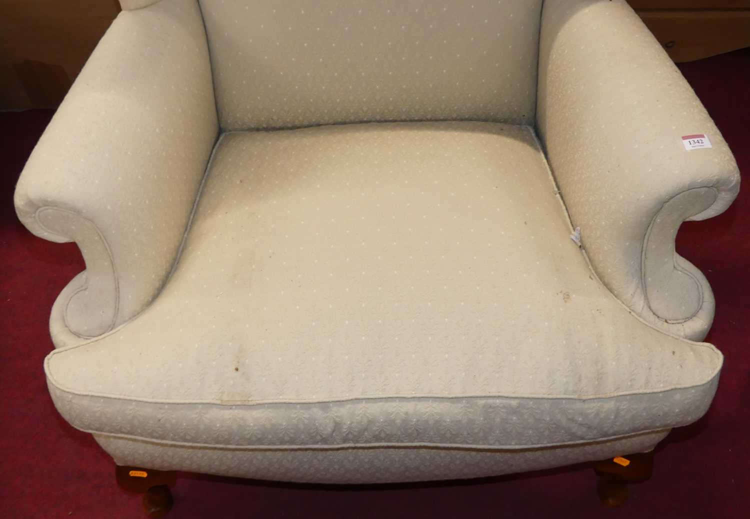 A contemporary cream floral fabric upholstered wingback scroll armchair, having squab cushion and - Image 4 of 4