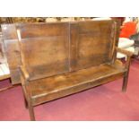 An antique joined oak and elm long bench settle, having a fold-over top, length 181cm Some losses
