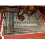 A Persian woollen green ground Bokhara rug, 190 x 130cm, together with a further Persian woollen red