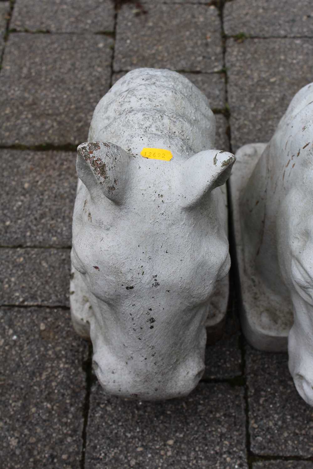 A pair of white painted reconstituted stone garden figural ornaments of horses' heads, length 38cm - Image 2 of 2