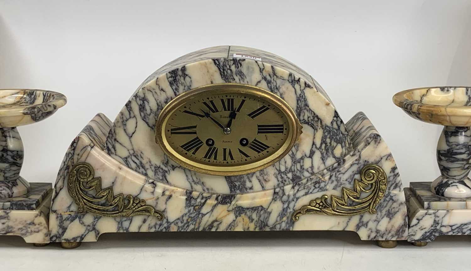 A French Art Deco veined marble three-piece clock garniture, clock height 22cm