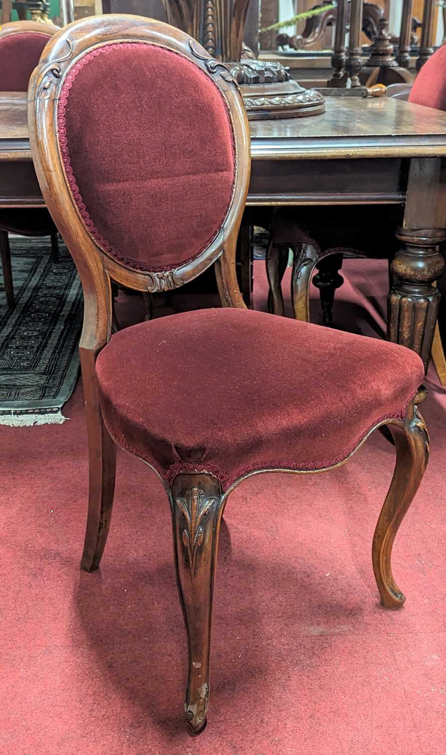 A set of six mid-Victorian mahogany balloon back salon side chairs, each with upholstered pad