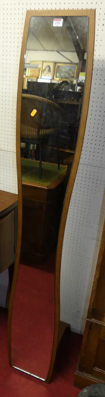 A contemporary plywood floor mirror, of slightly elongated hour glass form with rear support, height