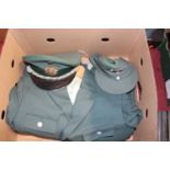 Two boxes of assorted police uniforms, to include German Bundesgrenzchutz tunic and cap etc