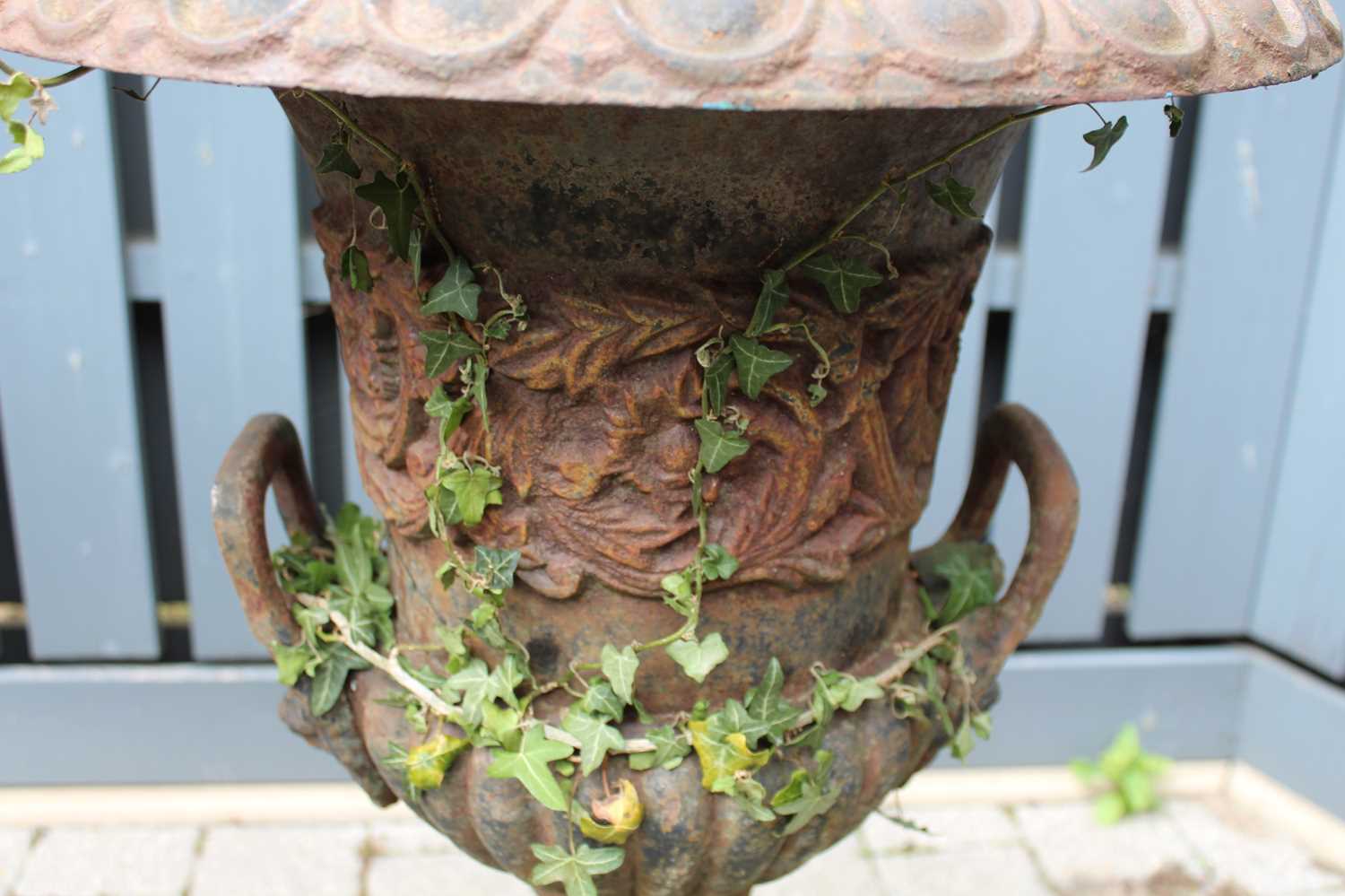 A pair of cast iron twin handled pedestal garden urns, raised on stepped tapering square bases, - Image 4 of 4