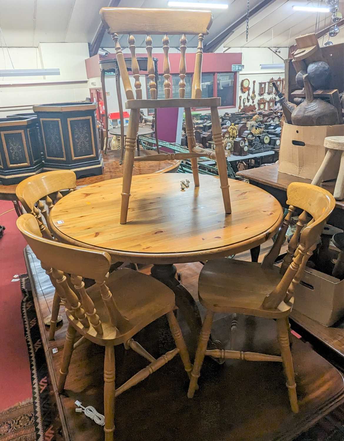 A modern pine circular breakfast table, dia.108cm; together with a set of four modern beech