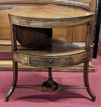 An early 19th century mahogany bowfront two-tier corner wash stand, having hinged raised back and
