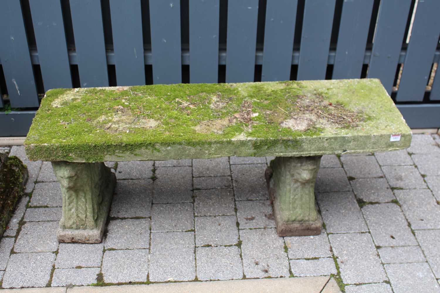 A concrete garden bench raised on twin pedestals, length 122cm