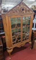 A George III pine freestanding double door astragal glazed corner cupboard, having an