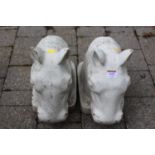 A pair of white painted reconstituted stone garden figural ornaments of horses' heads, length 38cm