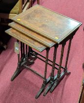 An early 20th century mahogany, flame mahogany and chequer inlaid nest of three occasional tables,