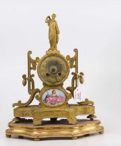 A mid 19th century French gilt metal mantel clock having porcelain inset panel below the dial,
