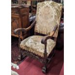 An early 20th century French walnut and acanthus leaf carved open armchair, having floral