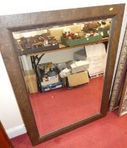 A contemporary bevelled rectangular wall mirror, with naturalistic frame, 112.5 x 92cm