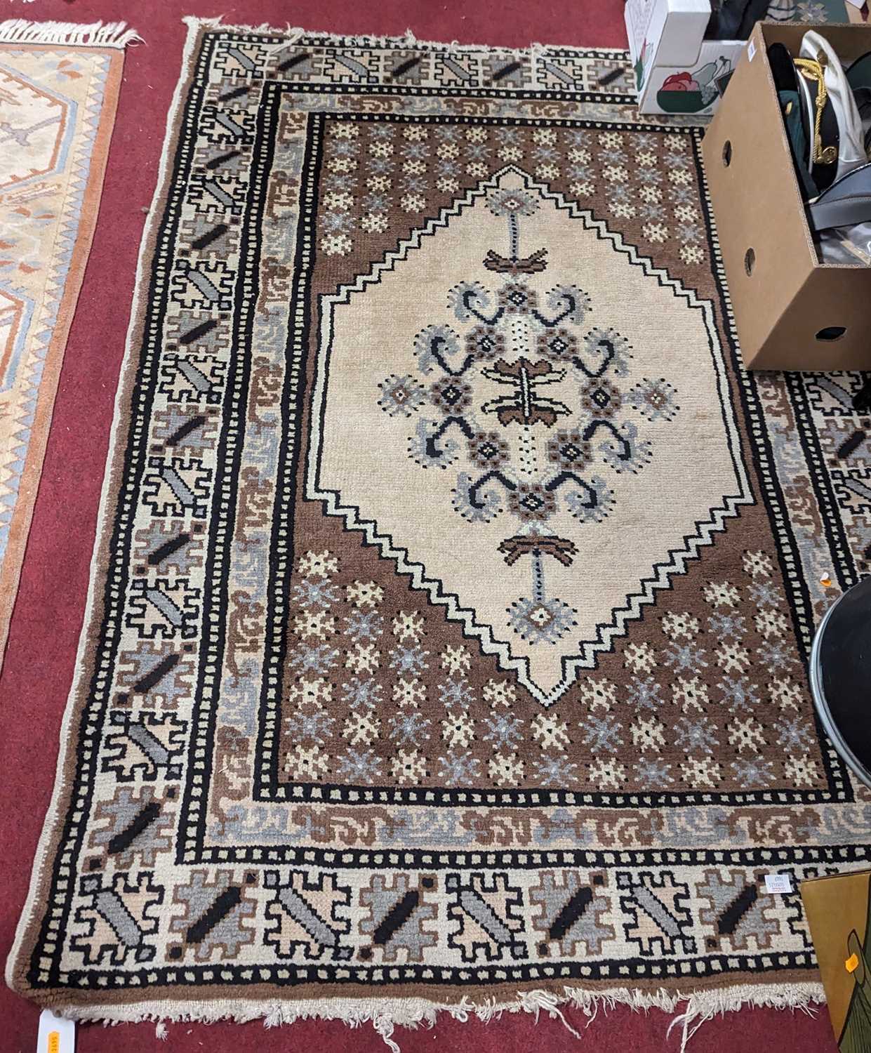 A Persian woollen cream and brown ground Catawiki rug, 165 x 125cm
