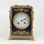 A circa 1900 gilt brass and ebonised mantel clock having unsigned white enamel dial and with brass