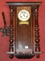 An early 20th century walnut cased Vienna drop trunk wall clock (incomplete), height 60cm