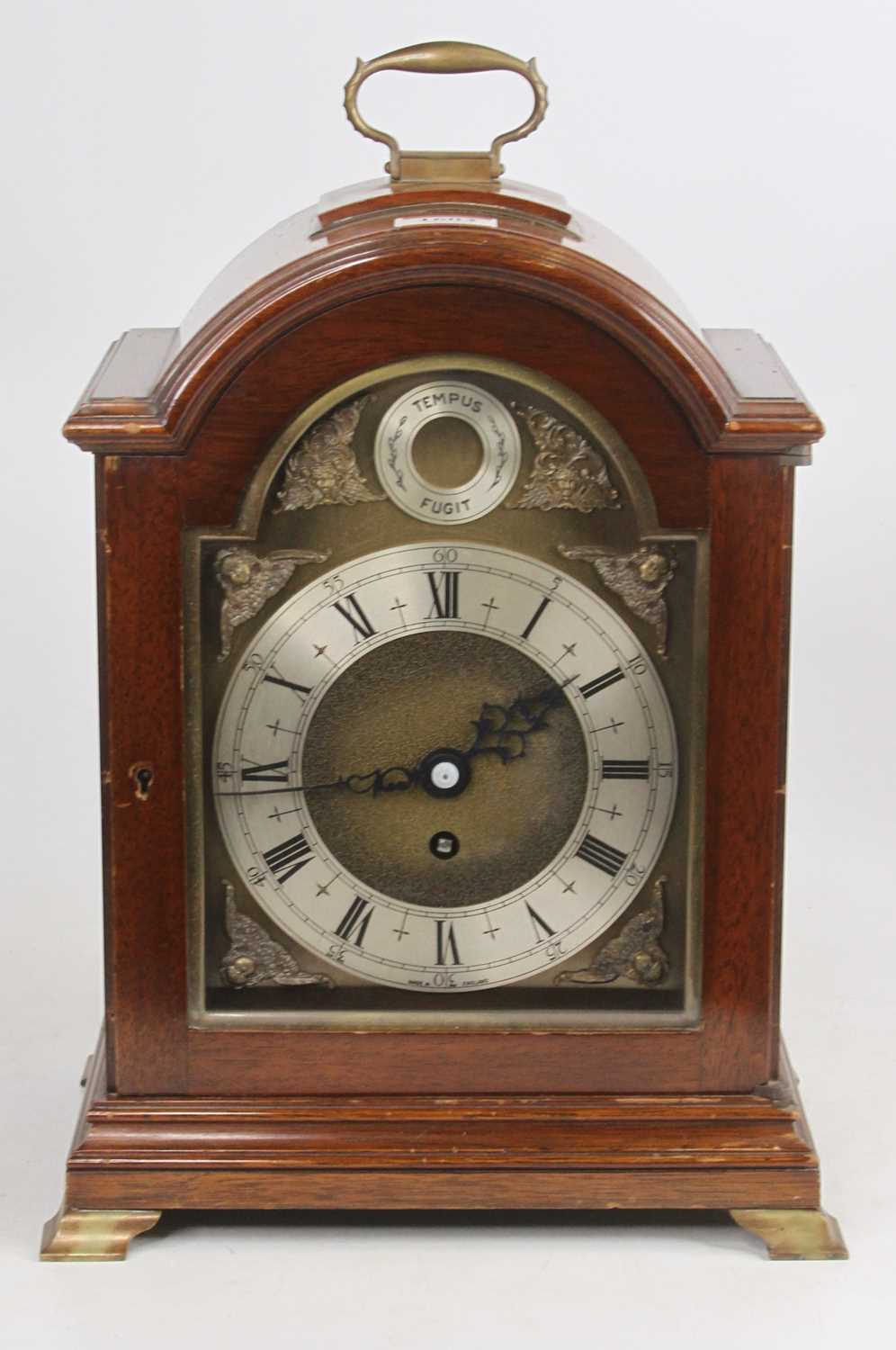 A Georgian style mahogany cased bracket clock having arched brass dial, height 34cm (handle down)