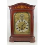 An early 20th century mahogany and inlaid mantel clock, the silvered chapter ring signed by the